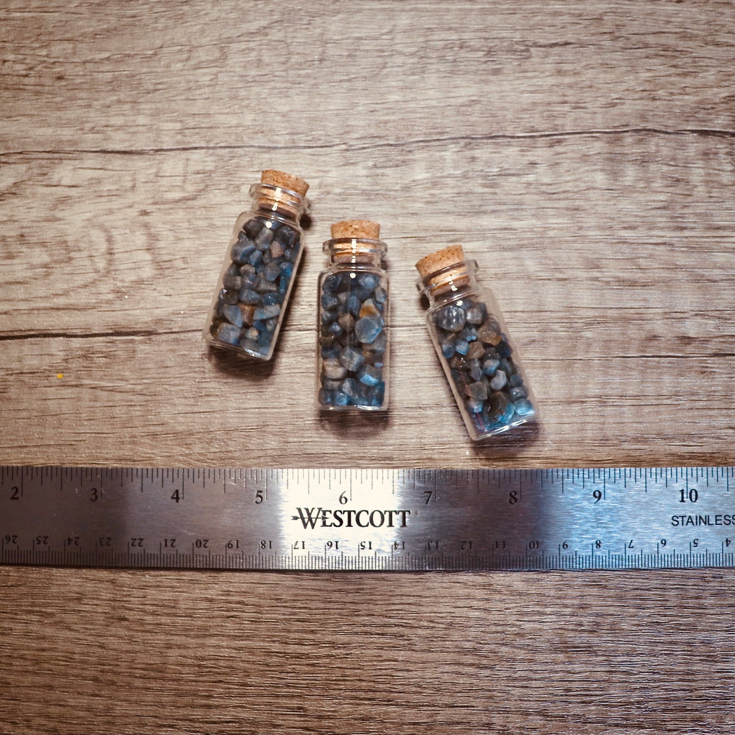 blue sapphire nuggets in glass bottle