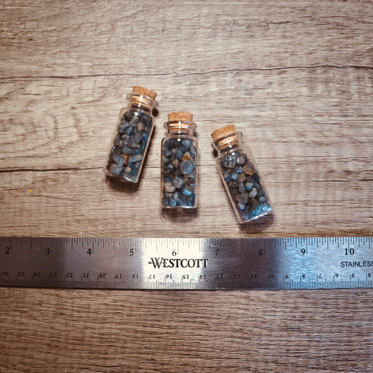 blue sapphire nuggets in glass bottle