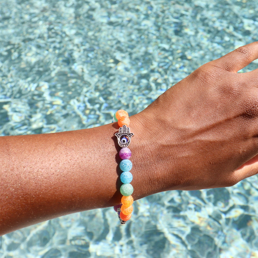 7 chakra bracelet made with cracked agate beads and fatima hand (hand of hamsa) charms