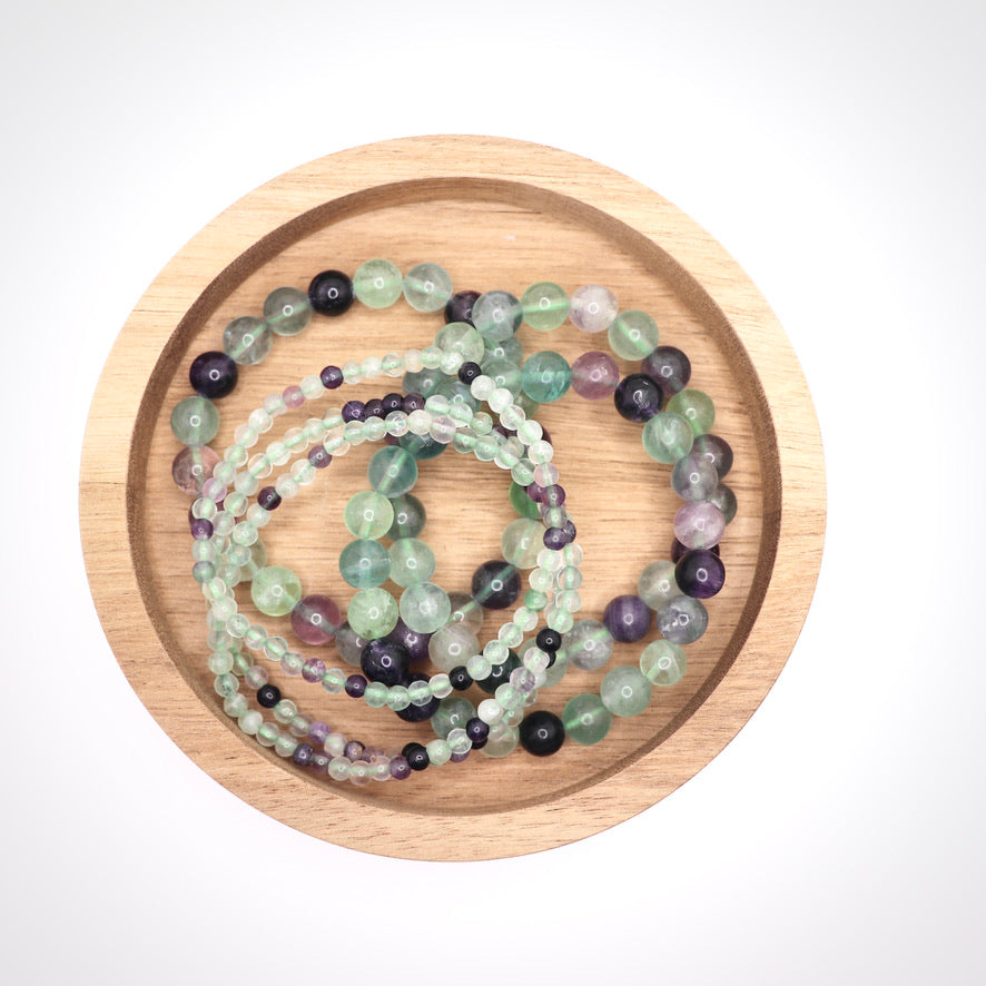 4 mm and 8 mm rainbow fluorite bracelet in wooden dish
