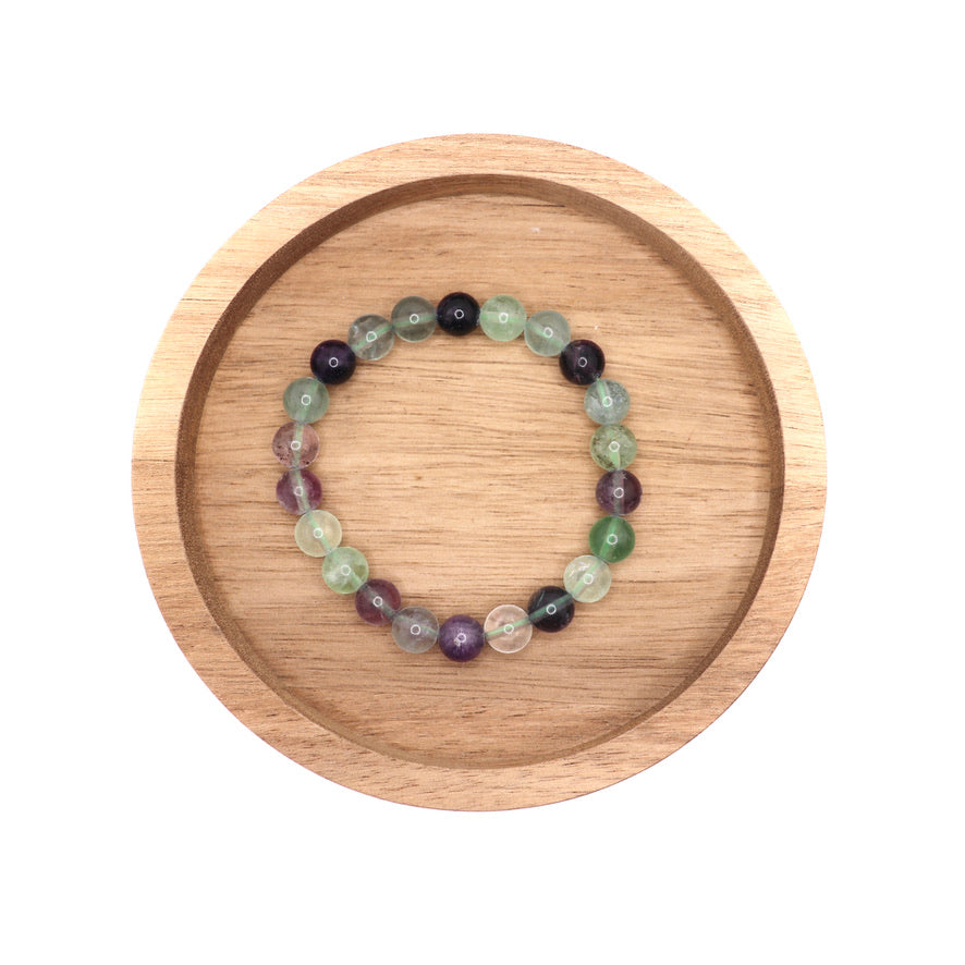 8 mm rainbow fluorite bracelet in wooden dish