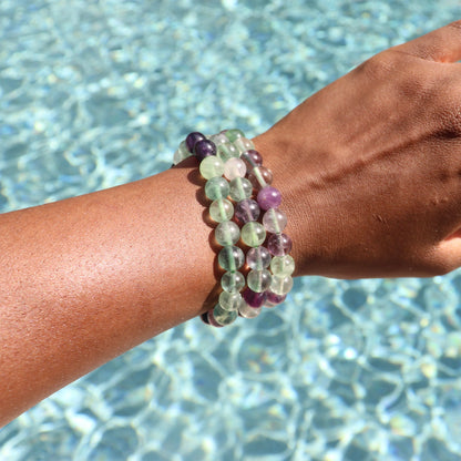 8 mm rainbow fluorite bracelet worn on African American